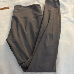 Athletic leggings, grayish, purple, snake print pattern.